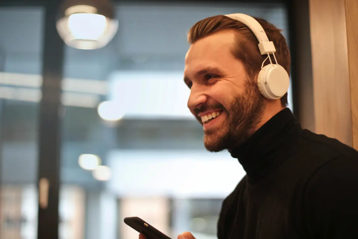 Happy radio host with headphones building listener relationships through engaging interactions
