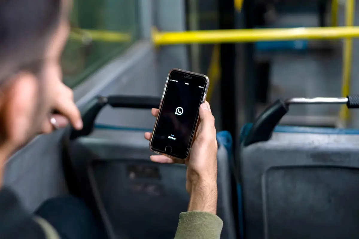 Listener on a bus opening WhatsApp